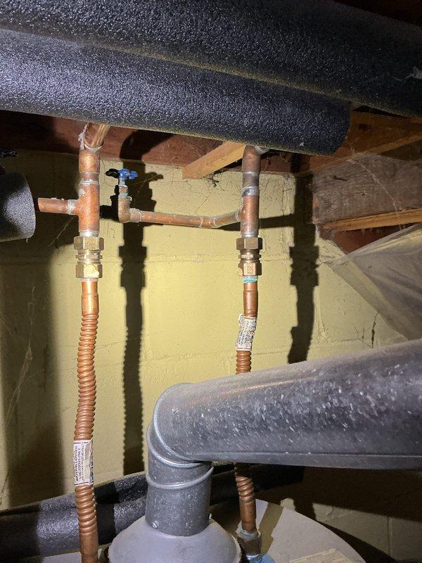 Completed water heater replacement in a 1947-built residence. Removed existing aging water heater unit and installed new replacement tank with proper venting and safety compliance. Connected gas supply line using flexible yellow corrugated tubing with appropriate shutoff valve and fittings. Installed copper water supply lines with brass compression fittings, ensuring secure connections for both hot and cold water distribution. Verified all plumbing connections for leaks, confirmed proper gas line installation, and tested unit operation. All work performed meets current plumbing codes and manufacturer specifications for safe water heater operation.