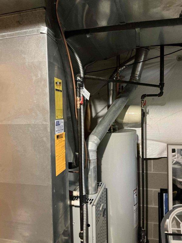Completed on-site assessment for furnace and air conditioning system replacement in residential basement mechanical room. Evaluated existing gray metal furnace/air handler unit with associated ductwork and outdoor condensing unit positioned on concrete pad against home exterior. Provided comprehensive replacement estimate covering both heating and cooling equipment, including evaluation of electrical connections, ductwork configuration, and outdoor unit placement with consideration for proper clearances and accessibility for future maintenance.
