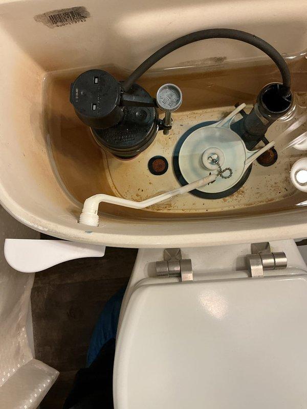 Responded to a toilet backing up in a mobile home. Upon arrival, inspected the toilet and found signs of waste material and staining in the bowl. Removed the tank lid to assess internal components and check for any mechanical issues affecting flush performance. Observed mineral buildup and sediment deposits in the tank, along with water staining on internal components. The fill valve, flush valve, float mechanism, and overflow tube were all examined and found to be functional. Addressed the backup issue through standard clearing procedures to restore proper drainage and flushing operation.