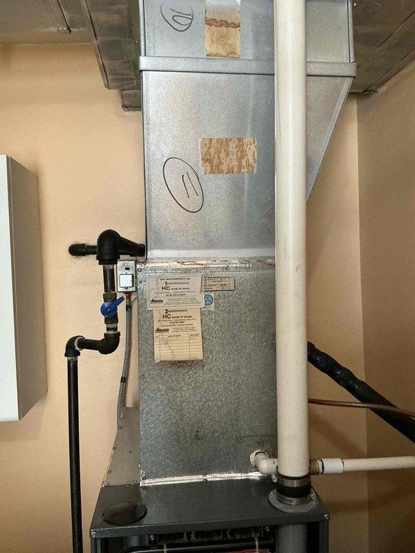 Conducted comprehensive on-site evaluation for complete HVAC system replacement involving existing furnace and air conditioning equipment. Documented current system configuration including vertical air handler installation, gas supply connections with shutoff valves, condensate drainage piping, and electrical components. Assessed ductwork integration, filter accessibility, and overall system condition to provide accurate replacement specifications and equipment recommendations.