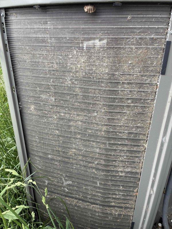 # HVAC Maintenance - Cooling

Performed annual preventive maintenance on a two-year-old residential air conditioning system. Upon arrival, conducted comprehensive inspection revealing severely soiled condenser coil with heavy accumulation of dirt, dust, debris, and white residue streaking that had significantly compromised heat transfer efficiency. Thoroughly cleaned condenser coil fins to restore proper airflow and heat exchange capability, removing caked-on environmental contaminants and organic matter. Inspected electrical control panel components including capacitor, contactors, and relay connections, verifying all wiring terminations were secure and electrical components were functioning within normal parameters. System restored to optimal operating condition and ready for cooling season demand.
