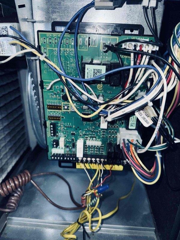 Responded to rescheduled AC maintenance visit for 5-year-old system. Upon arrival, performed comprehensive system inspection and diagnostics. Examined control board assembly and electrical components within the cabinet, verifying proper connections and functionality of the dual-board control system. Inspected the run capacitor and identified visible heat damage and charring on the component surface, indicating electrical stress or failure. The capacitor showed a rated capacity of 45/5 MFD at 370/440VAC. Documented all findings with photographic evidence of the control panel wiring configuration and the deteriorated capacitor condition for service records and warranty purposes. System evaluation completed and customer advised of findings.