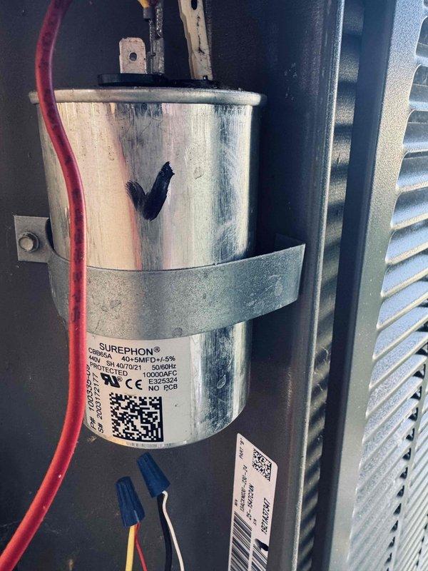 Responded to rescheduled AC maintenance visit for 5-year-old system. Upon arrival, performed comprehensive system inspection and diagnostics. Examined control board assembly and electrical components within the cabinet, verifying proper connections and functionality of the dual-board control system. Inspected the run capacitor and identified visible heat damage and charring on the component surface, indicating electrical stress or failure. The capacitor showed a rated capacity of 45/5 MFD at 370/440VAC. Documented all findings with photographic evidence of the control panel wiring configuration and the deteriorated capacitor condition for service records and warranty purposes. System evaluation completed and customer advised of findings.