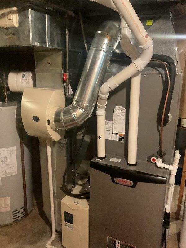 Completed annual air conditioning maintenance on a 5-year-old system. Performed comprehensive inspection of HVAC equipment including furnace/air handler unit, verified proper operation of all components, checked refrigerant levels and system temperatures with digital measurement tools recording 66.3°F readings, inspected condensate drainage system and PVC piping connections, examined exhaust venting and flue assembly for proper sealing, and confirmed all safety controls and shutoff valves were functioning correctly. System operating within normal parameters with no issues identified.
