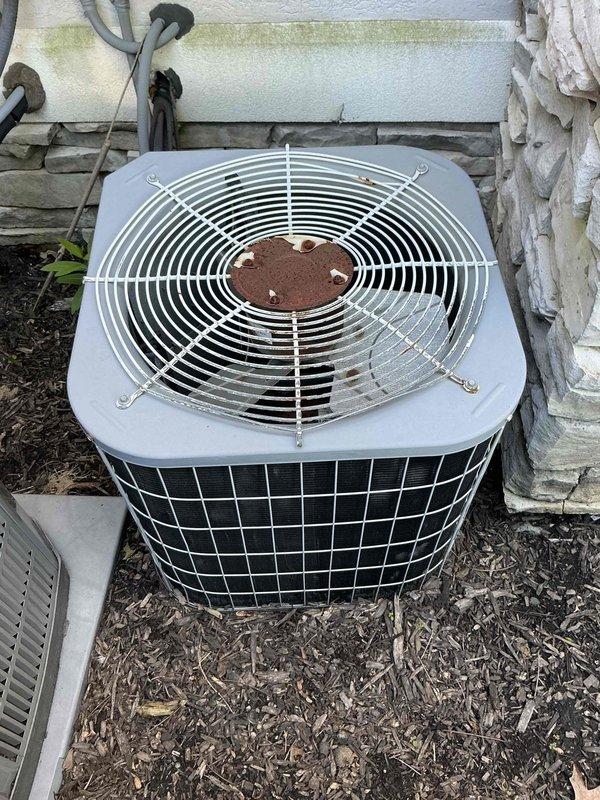 Conducted comprehensive assessment for HVAC system replacement at large residential property exceeding 3000 square feet requiring heating and cooling solutions with electric heat pump configuration and basement unit installation. Evaluated existing outdoor condenser unit showing significant corrosion at fan hub and aging components, as well as electrical service capacity with dual panel system to ensure adequate power supply for proposed furnace, air conditioning, tankless water heater, and backup generator installation. Documented current equipment conditions and electrical infrastructure to develop appropriate replacement specifications for complete system upgrade.