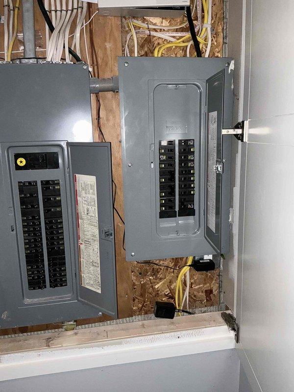 Conducted comprehensive assessment for HVAC system replacement at large residential property exceeding 3000 square feet requiring heating and cooling solutions with electric heat pump configuration and basement unit installation. Evaluated existing outdoor condenser unit showing significant corrosion at fan hub and aging components, as well as electrical service capacity with dual panel system to ensure adequate power supply for proposed furnace, air conditioning, tankless water heater, and backup generator installation. Documented current equipment conditions and electrical infrastructure to develop appropriate replacement specifications for complete system upgrade.