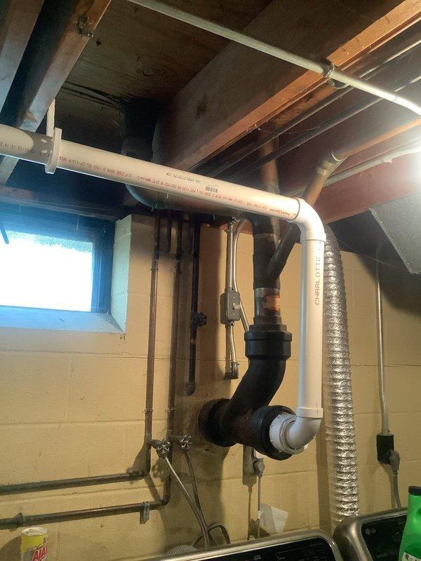 Responded to water leak investigation after previous contractors provided conflicting diagnoses regarding roof versus plumbing issues. Performed comprehensive assessment of exposed ceiling area and basement utility space, identifying significant water damage along interior walls with extensive staining and moisture intrusion. Documented existing plumbing infrastructure including vertical PVC drainage system, overhead waste lines, and basement piping configuration. Provided detailed photographic documentation of damaged areas and existing plumbing conditions to support accurate quote preparation for necessary repairs.