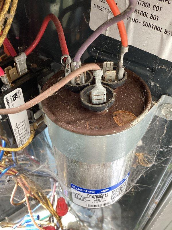 Completed air conditioning maintenance and system inspection. Evaluated condenser unit components including Genteq motor capacitor, which displayed significant rust and corrosion on top plate but remained operational. Checked electrical connections and wiring integrity throughout system. Measured system temperatures and verified 96.0 AFUE rated Z-Line Series unit performance parameters. Noted ductwork condition for potential cleaning recommendation. Unit age unknown; system currently functioning within acceptable parameters.