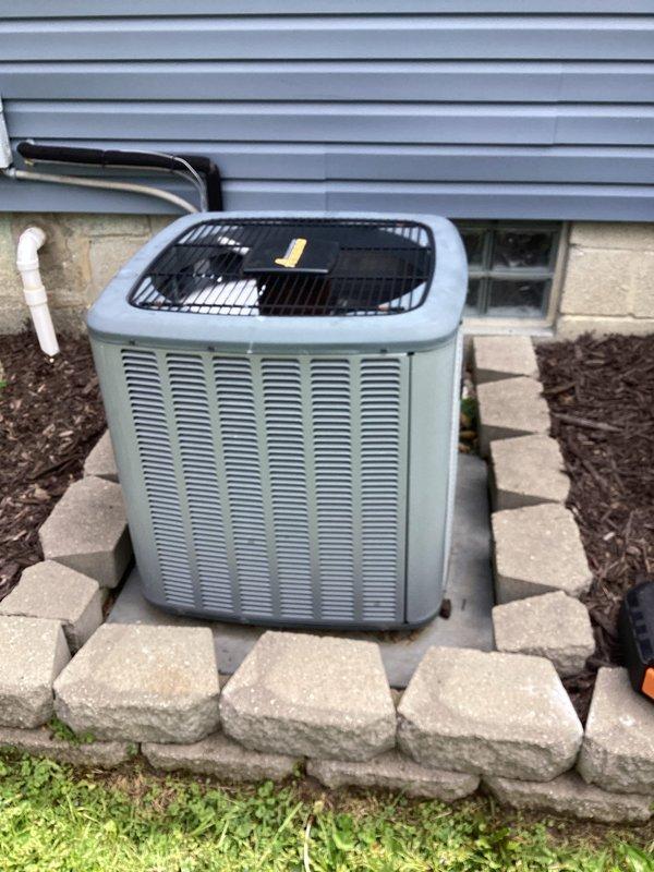 Performed routine air conditioning maintenance on residential split system with outdoor condenser unit. Completed standard inspection of equipment including condenser coils, refrigerant lines, and electrical connections. Assessed ductwork condition for potential cleaning needs and documented equipment status with photos for customer records.
