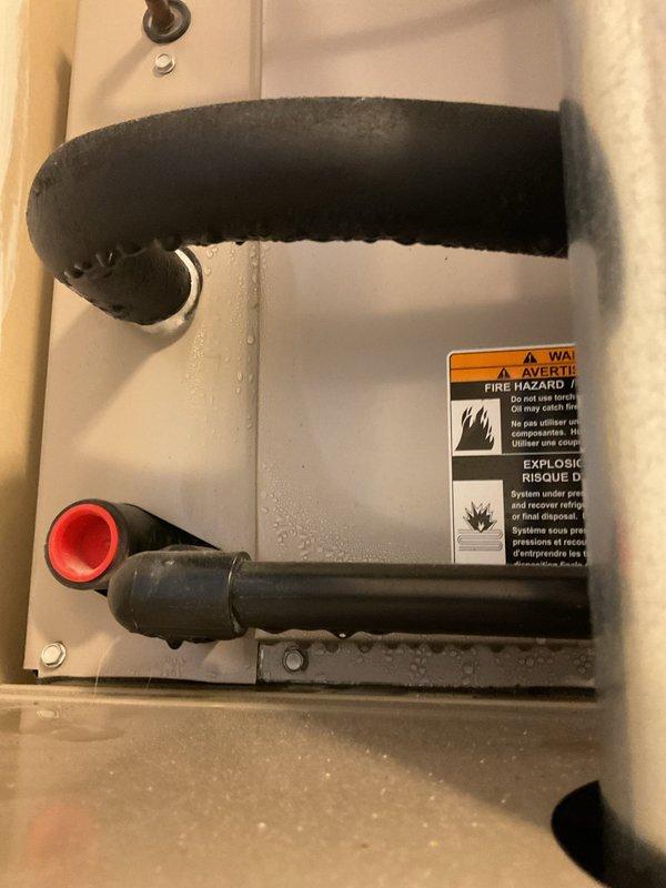 Responded to no cooling complaint at rental property. Upon inspection, found central A/C system with refrigerant issue indicated by accessible service ports on suction and liquid lines. Evaluated system components including furnace air handler and refrigerant piping connections. System assessed and documented for property management records.