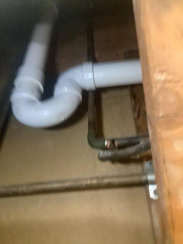 Responded to failed plumbing inspection due to venting code violations for shower and tub installations not meeting 2024 Ohio plumbing code requirements. Removed all existing cast iron piping from basement through second floor of split-level home servicing both bathrooms. Rebuilt complete drainage stack system installing new waste and overflow assemblies for both bathrooms, new P-traps for both toilets and lavatories, and ran new Schedule 40 PVC stack to basement with cleanout access. All piping properly secured to structural framing members with metal fastening straps and configured with appropriate elbow joints for proper drainage and venting throughout the system.