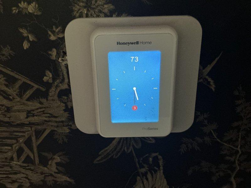Conducted comprehensive estimate for complete HVAC system replacement following fire damage to residential property. Assessed existing flexible ductwork in ceiling joists showing heat damage and compromised insulation, evaluated wall-mounted Honeywell Home ProSeries thermostat for replacement compatibility, and documented extensive structural exposure requiring new furnace, air conditioning unit, and complete ductwork installation throughout affected areas with coordination of electrical components.