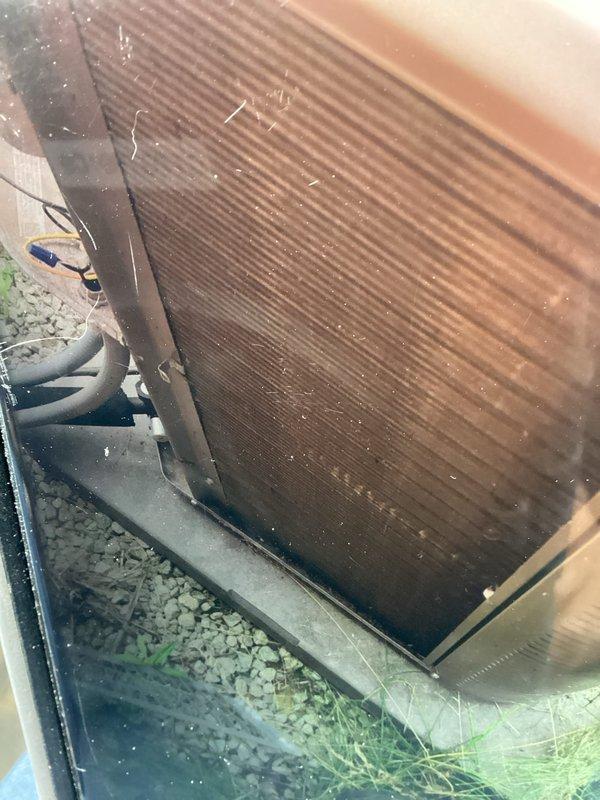 Completed routine maintenance visit on 4-year-old air conditioning system. Inspected indoor blower wheel assembly, which showed moderate dust accumulation on blades and housing but remained operational. Examined outdoor condensing unit and found significant debris buildup on condenser coil fins with visible dirt, grime, and cobweb material affecting heat transfer efficiency. Unit was functional at time of inspection, though cleaning would improve performance and system efficiency.