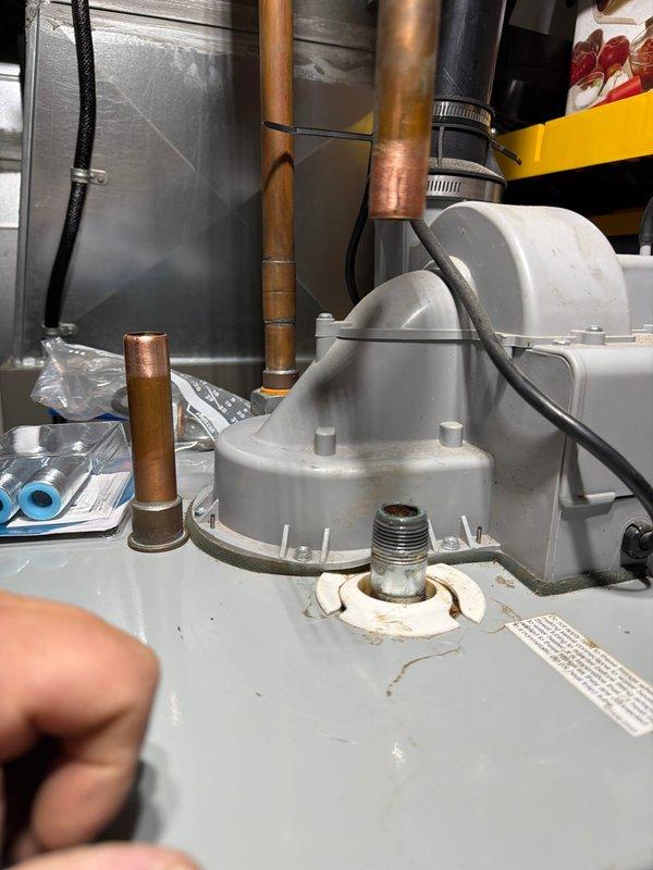 Responded to service call for leaking electric water heater in 22-year-old residential property. Upon inspection, identified active leak at dielectric union connection on hot water outlet. Per customer request, replaced both hot and cold side dielectric unions and installed new insulating nipples to prevent galvanic corrosion and extend equipment lifespan. Inspected and replaced anode rod due to age and deterioration. Verified all connections for proper seal, tested system operation, and confirmed no active leaks present upon completion.