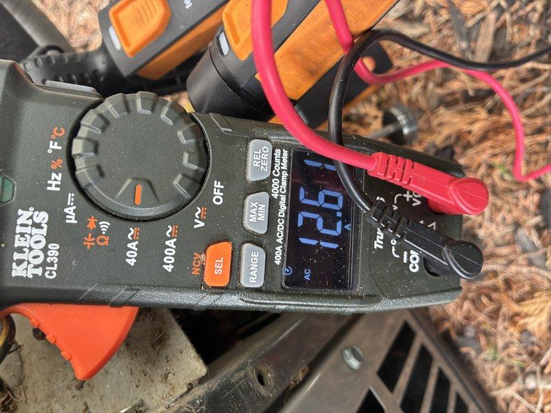 Completed comprehensive AC tune-up and system inspection, including electrical testing with clamp meter showing 16.6 amp reading, ductwork examination, and complimentary carbon monoxide detector installation. All components inspected and found operating within normal parameters, with system ready for cooling season operation.
