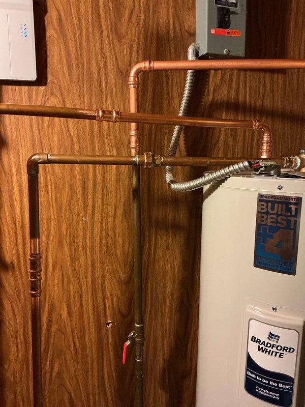 Replaced existing 80-gallon electric water heater with new 50-gallon Bradford White electric unit including 10-year warranty. Installed expansion tank and complete water heater kit with all necessary connections. Removed old unit, installed new water heater with proper copper piping connections, flexible connectors, shut-off valves, and electrical hookup to existing breaker panel. All plumbing connections tested and verified operational upon completion.