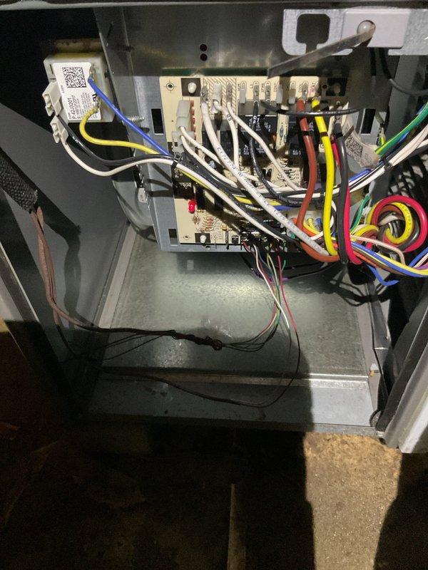 Performed maintenance inspection on 8-year-old Lennox furnace system with reported blower motor concerns. Accessed and evaluated internal control board wiring, terminal connections, and electrical components within the unit compartment. Documented equipment condition through photography of control board assembly and overall furnace installation, noting complex wiring configuration and system connections including ductwork and PVC venting components.