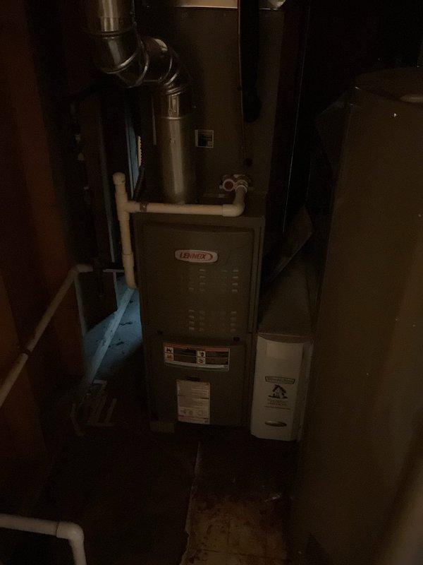 Performed maintenance inspection on 8-year-old Lennox furnace system with reported blower motor concerns. Accessed and evaluated internal control board wiring, terminal connections, and electrical components within the unit compartment. Documented equipment condition through photography of control board assembly and overall furnace installation, noting complex wiring configuration and system connections including ductwork and PVC venting components.