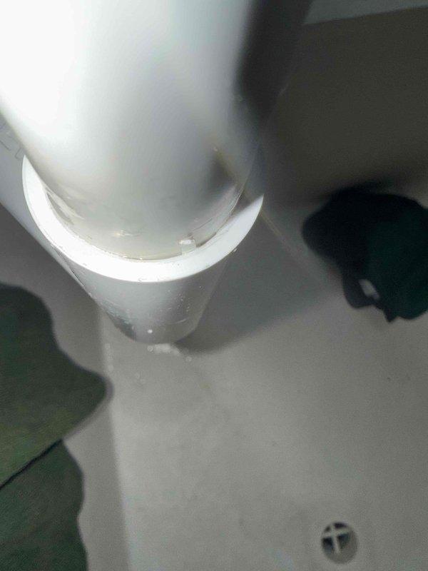 Responded to call regarding air conditioning condensate leak dripping onto electrical box. Upon inspection, discovered primary condensate drain line with unglued PVC fitting in attic space above air handler unit. The improper connection was allowing water to leak from the joint rather than draining properly through the condensate line. Identified and documented the failed connection, which was causing water to bypass the intended drainage path and create a safety hazard near electrical components.