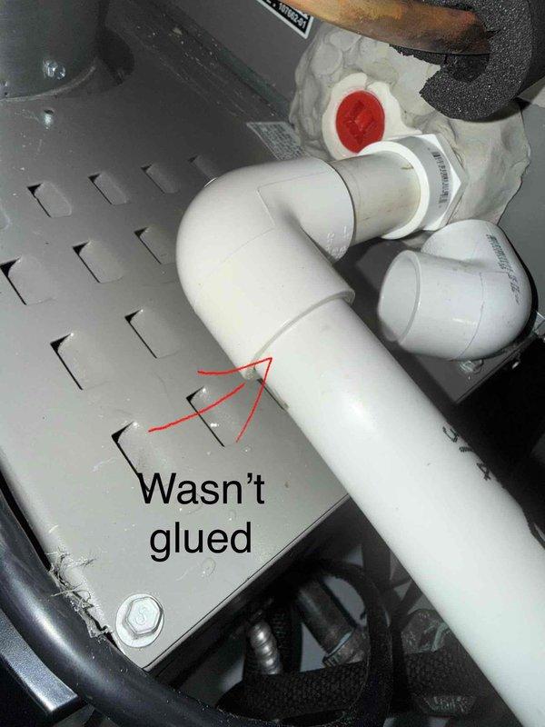 Responded to call regarding air conditioning condensate leak dripping onto electrical box. Upon inspection, discovered primary condensate drain line with unglued PVC fitting in attic space above air handler unit. The improper connection was allowing water to leak from the joint rather than draining properly through the condensate line. Identified and documented the failed connection, which was causing water to bypass the intended drainage path and create a safety hazard near electrical components.