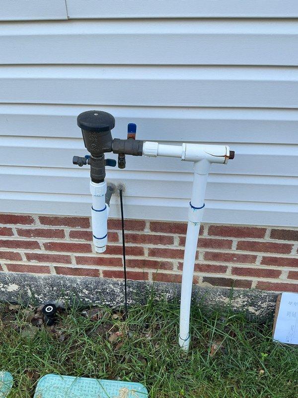 Completed annual backflow prevention testing on 20-year-old sprinkler system assembly mounted on building exterior. Inspected backflow preventer device, test cocks, and shut-off valves; verified proper operation of check valves and relief valve; documented all test results and confirmed equipment meets current cross-connection control standards.