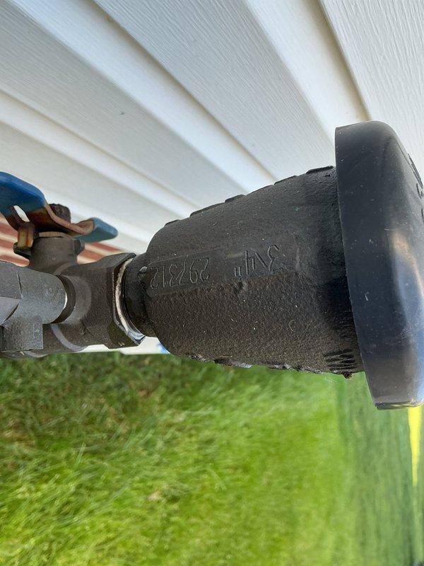 Completed annual backflow prevention testing on 20-year-old sprinkler system assembly mounted on building exterior. Inspected backflow preventer device, test cocks, and shut-off valves; verified proper operation of check valves and relief valve; documented all test results and confirmed equipment meets current cross-connection control standards.