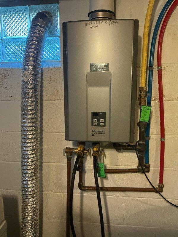 Performed descaling maintenance on wall-mounted Rinnai tankless water heater installed in January 2010. Flushed unit using isolation valves and collection basin to remove mineral buildup and restore optimal heat exchanger efficiency. Unit operational upon completion with all connections verified leak-free.