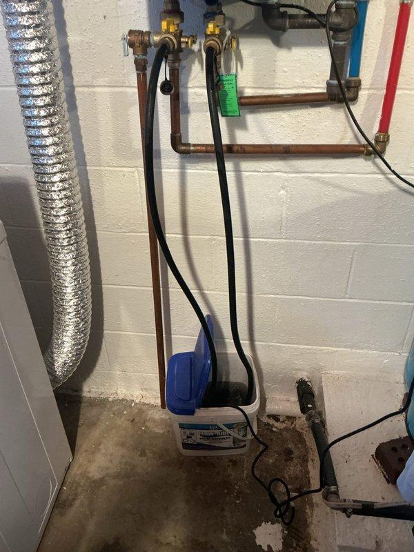 Performed descaling maintenance on wall-mounted Rinnai tankless water heater installed in January 2010. Flushed unit using isolation valves and collection basin to remove mineral buildup and restore optimal heat exchanger efficiency. Unit operational upon completion with all connections verified leak-free.