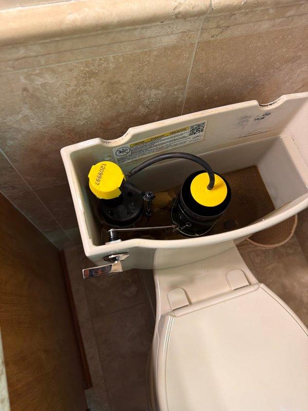 Responded to service call for multiple plumbing fixtures requiring attention. Inspected kitchen faucet with sensitivity issues causing intermittent leaking when nozzle positioning was not precise, evaluated second-floor bathroom sink faucet with slow drip condition, and assessed toilet tank components requiring replacement. Documented all fixtures with photographic evidence showing double-basin kitchen sink with pull-down faucet assembly and toilet tank interior with worn flush mechanism components for replacement recommendations.