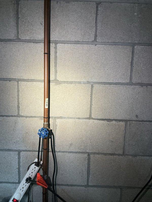 Conducted site assessment for new 3/4" backflow preventer installation in basement utility area. Evaluated existing copper water supply line configuration, structural mounting requirements, and clearance specifications per local plumbing code. Photographed current plumbing infrastructure including vertical copper supply pipe with existing shut-off valve, concrete block wall mounting surface, and surrounding mechanical systems. Provided customer with detailed quote for backflow device installation including required materials, labor, and compliance with municipal backflow prevention regulations.