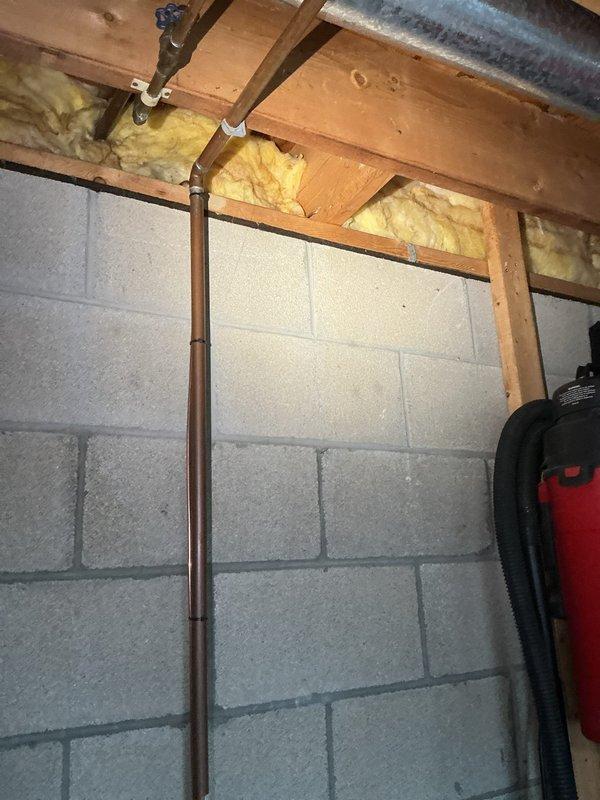 Conducted site assessment for new 3/4" backflow preventer installation in basement utility area. Evaluated existing copper water supply line configuration, structural mounting requirements, and clearance specifications per local plumbing code. Photographed current plumbing infrastructure including vertical copper supply pipe with existing shut-off valve, concrete block wall mounting surface, and surrounding mechanical systems. Provided customer with detailed quote for backflow device installation including required materials, labor, and compliance with municipal backflow prevention regulations.