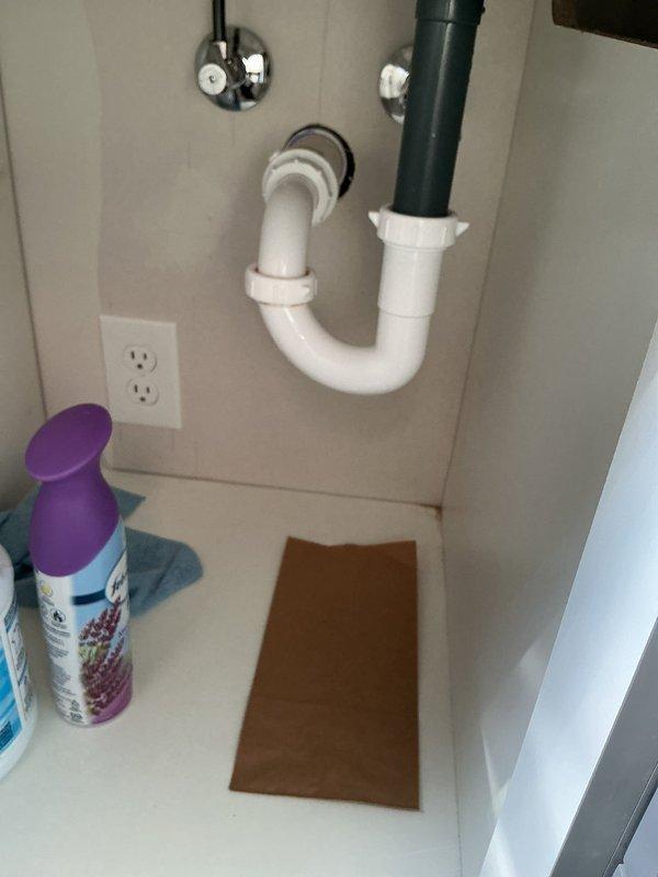 Responded to service call for reported leak and water puddle in basement beneath bathroom, along with sewer gas odor in bathroom. Upon arrival, conducted thorough inspection of bathroom plumbing fixtures and basement area directly below. 

Investigated shower drain assembly and discovered significant mold and mildew accumulation around central drain, indicating chronic moisture issues and potential drainage problems. Examined P-trap assembly and drainage connections under bathroom sink, finding all connections secure with no visible active leaks at time of inspection. Inspected water supply shut-off valves and supply lines, confirming proper operation and no signs of corrosion or leakage.

Assessed basement ceiling area beneath bathroom for source of reported water accumulation. Identified moisture intrusion likely originating from shower pan drainage system or compromised shower pan seal. The extensive mold growth pattern radiating from shower drain suggests prolonged water seepage th