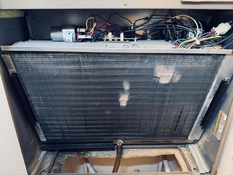 Performed annual maintenance on an 18-year-old residential air conditioning system. Inspected evaporator coil and air handler unit, noting dust and dirt accumulation on aluminum fins. Verified electrical connections, capacitors, and control modules; confirmed proper operation of all components and documented system condition with photographs.