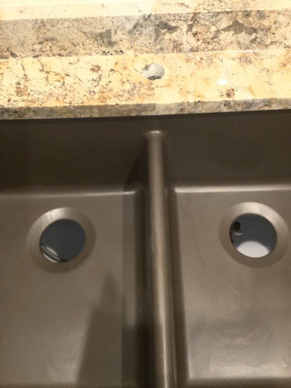 Completed installation and hookup of bathroom sink faucet in double-basin vanity. Connected water supply lines to faucet assembly, installed P-trap drainage system with proper venting, and verified all connections for leaks. All plumbing components are functioning properly with no visible leaks detected upon testing.
