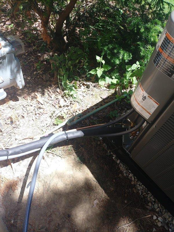 Completed installation of new air conditioning system with matching evaporator coil at residential property. Installed outdoor condensing unit on gravel pad with proper refrigerant line routing through landscaped area, verified 30-amp fuse protection at disconnect, and confirmed system operational upon startup.