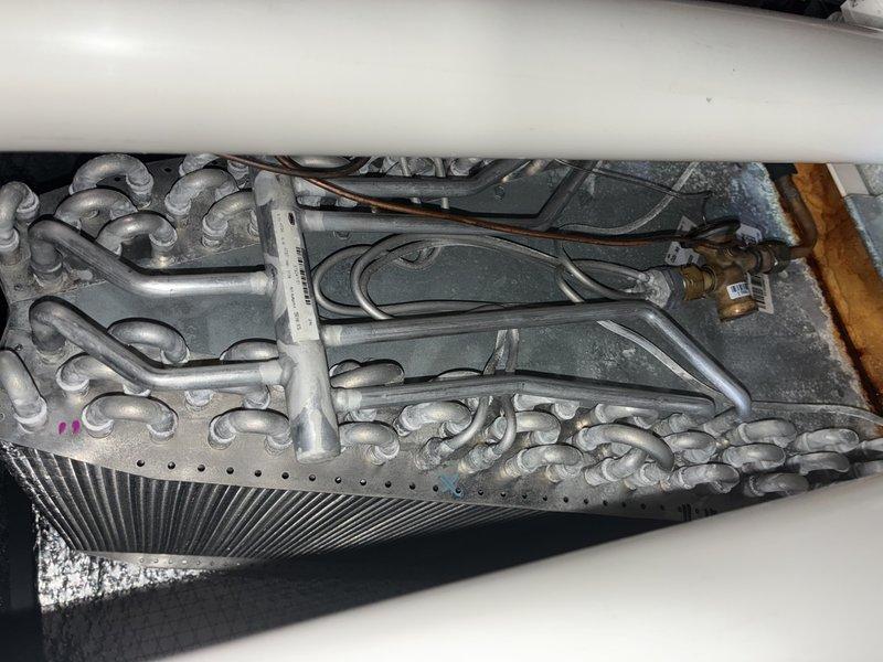 Completed annual preventative maintenance on residential air conditioning system for contract holder with five to six year old unit. Performed comprehensive inspection of evaporator coil assembly, verified refrigerant line connections and brass fittings for proper seal integrity, and examined electronic control board system including all PCB components, wire harnesses, and connector terminals. Inspected aluminum coil fins for damage, checked condensate drainage system including PVC piping, and verified all electrical connections and control circuits were secure and functioning properly. Unit operating within normal parameters upon completion of maintenance service.