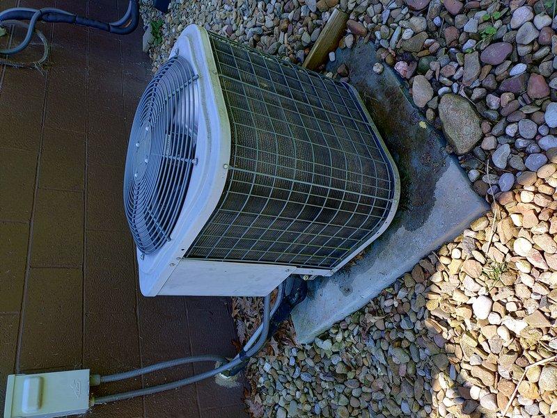 Completed MVP recurring cooling maintenance visit on outdoor condenser unit. Performed standard inspection of unit positioned on concrete pad with decorative rock landscaping, noting the second unit was recently replaced and not requiring service at this time. Inspected fan assembly, condenser coils behind protective metal grille, and refrigerant line connections. Unit showed normal weathering consistent with outdoor exposure, with operational components functioning within normal parameters. All maintenance tasks completed per service agreement specifications.