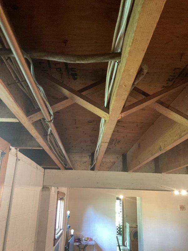 Completed electrical wiring installation for new septic system in basement utility area. Routed necessary electrical circuits through exposed ceiling joists to support septic system operation, with no additional parts required for the installation.