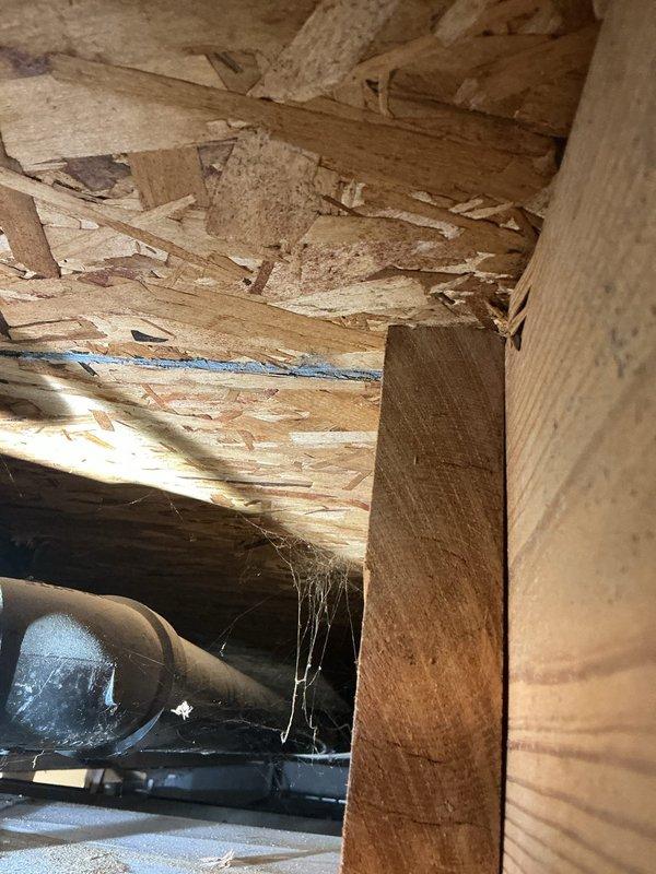 Responded to service call for water backing up in basement with suspected sump pump issue. Upon arrival, performed thorough inspection of crawl space and basement area to identify source of water intrusion. Examined subfloor structure, exposed joists, and plumbing infrastructure including visible PVC piping and drainage systems. Documented significant deterioration of subflooring materials with evidence of moisture damage, delamination, and structural degradation consistent with ongoing water exposure. Identified compromised building materials and potential water infiltration points requiring further assessment and remediation.