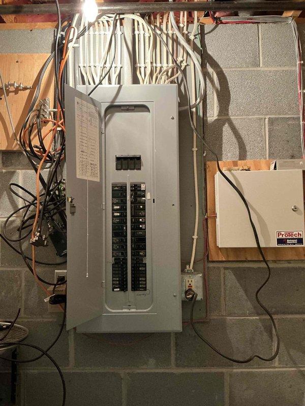 Conducted on-site electrical assessment for generator installation at residential property. Evaluated existing 200-amp main service panel and electrical infrastructure to determine compatibility and requirements for backup generator system integration. Documented current panel configuration, available breaker spaces, and wire routing from main distribution panel to determine optimal connection point for automatic transfer switch. Assessed secondary electrical enclosure and associated wiring to verify adequate capacity for proposed generator load. Photographed electrical service equipment and panel layout for estimate preparation and future installation planning.