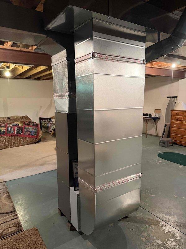 Completed full HVAC system installation including 80% efficiency furnace and air conditioning condenser unit. Installed Lennox brand outdoor AC condenser on concrete pad with proper clearances and drainage, connected refrigerant lines and electrical service, and installed condensate drain line. Fabricated and installed new vertical supply ductwork in basement with properly sealed joints and transitions to existing distribution system. System tested and verified operational with proper airflow and temperature differentials.