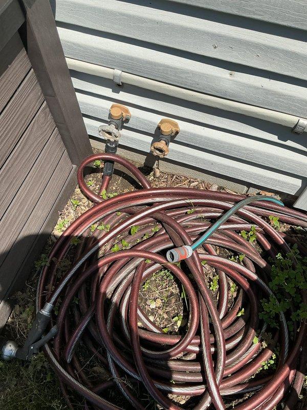 Responded to service call for leaking exterior cold water spigot. Upon arrival, found hose stuck on the leaking spigot and confirmed shut-off valves in crawlspace had already been turned off by property owner. Accessed crawlspace to inspect plumbing infrastructure and shut-off valve locations. Successfully removed stuck hose from spigot coupling. Assessed spigot condition and determined source of leak. Documented existing plumbing configuration including hot and cold water exterior faucet locations and crawlspace valve access points for future reference.