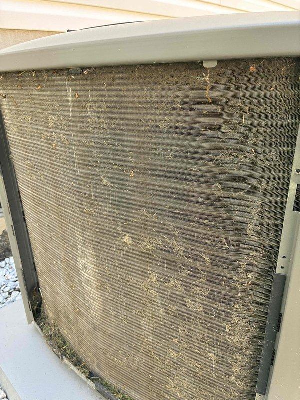 Completed MVP cooling maintenance visit on Lennox outdoor unit. Inspected condenser coil and found significant accumulation of dirt, dust, debris, and organic matter blocking airflow through fins, particularly heavy on right side and bottom sections. Cleaned condenser coil to restore proper heat transfer efficiency and system performance. Verified unit operation, electrical disconnect, and proper installation on concrete pad with adequate clearances.