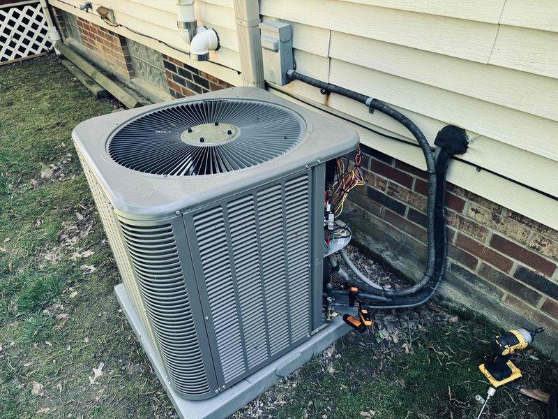 Completed preventive maintenance inspection on residential cooling system. Performed electrical diagnostics using digital multimeter, recording system voltage and verifying proper electrical operation of outdoor condensing unit. Inspected exterior condenser unit including fan assembly, refrigerant line connections, and electrical conduit routing along building exterior. System operating within normal parameters at time of inspection.