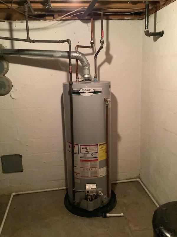 Responded to service call for 19-year-old A.O. Smith water heater producing loud popping noises during operation. Performed complete tank flush to remove sediment buildup, which is the primary cause of popping sounds in aging water heaters. The sediment accumulation at the tank bottom creates steam bubbles that burst and cause the characteristic popping noise. Drained tank completely through drain valve, flushed with fresh water until discharge ran clear, and refilled system. Inspected all connections, copper supply lines, and shut-off valves for proper operation. Verified temperature and pressure relief valve functionality and checked drain pan placement. Unit returned to normal quiet operation following sediment removal.