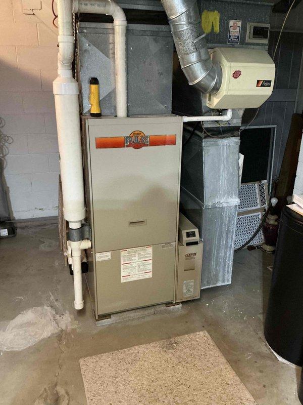 Completed furnace and air conditioning replacement estimate for property going through home warranty process. Assessed existing Heil/Ruud furnace system in basement utility area with associated ductwork, humidifier, and PVC venting configuration to provide comprehensive replacement specifications and confirmed details with customer.