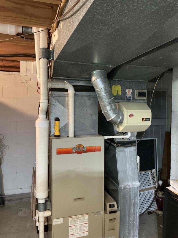 Completed furnace and air conditioning replacement estimate for property going through home warranty process. Assessed existing Heil/Ruud furnace system in basement utility area with associated ductwork, humidifier, and PVC venting configuration to provide comprehensive replacement specifications and confirmed details with customer.