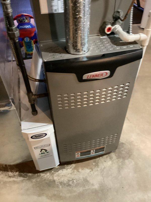 Performed routine maintenance on a 4-year-old Lennox cooling system. Inspected air filter and found moderate dust accumulation; filter assessed for replacement consideration. Examined furnace cabinet, ductwork connections, and associated HVAC components including flexible metallic ducts, rigid piping, and PVC condensate line. Verified proper installation of ball valve and metallic tubing connections. All system components operating within normal parameters.