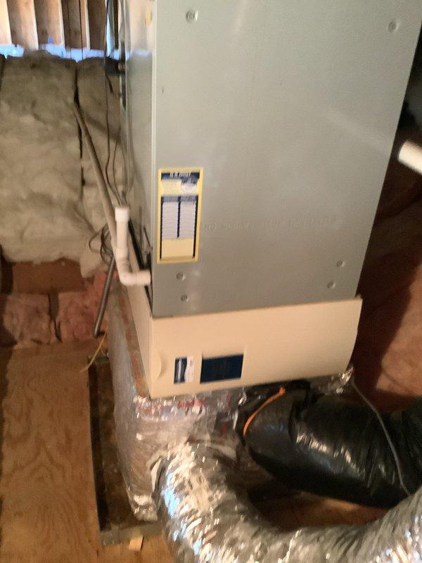 Performed estimate for heat pump replacement in walk-in attic for 19-year-old system. Assessed existing air handler unit with exposed electrical panel, refrigerant lines, and flexible ductwork in unfinished space with fiberglass insulation between studs. Provided quote for leak search and refrigerant recharge service as alternative option to full system replacement.