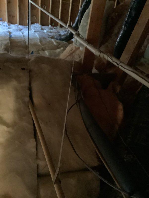 Performed estimate for heat pump replacement in walk-in attic for 19-year-old system. Assessed existing air handler unit with exposed electrical panel, refrigerant lines, and flexible ductwork in unfinished space with fiberglass insulation between studs. Provided quote for leak search and refrigerant recharge service as alternative option to full system replacement.